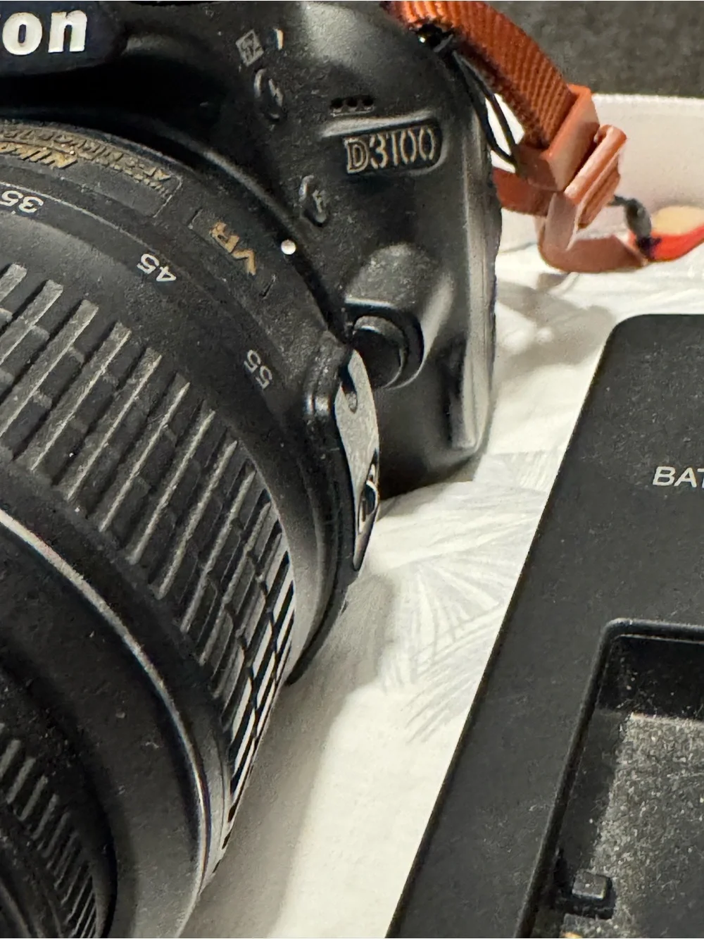 Nikon DSLR Camera with Black Lens and Black Charger